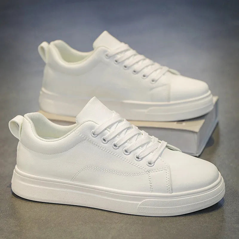 Men's low-top casual sneakers in black, white, or black with white bottom, showing round toe and flat rubber sole.