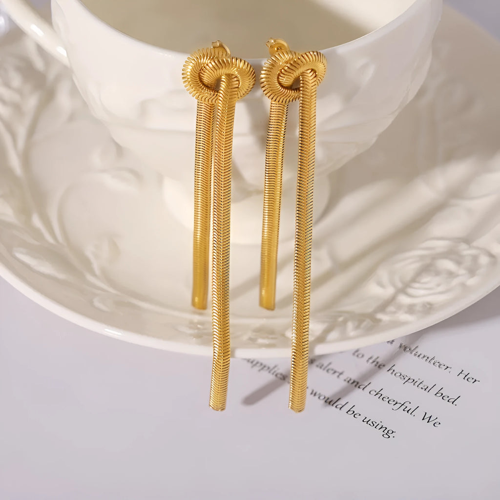 Gold knotted tassel pendant on long snake chain necklace with matching titanium steel earrings