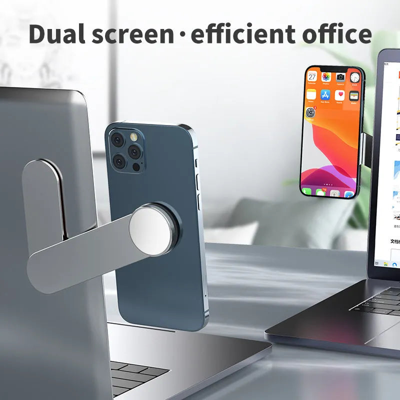 Silver aluminium alloy magnetic mobile phone bracket on desk with laptop for dual screen use