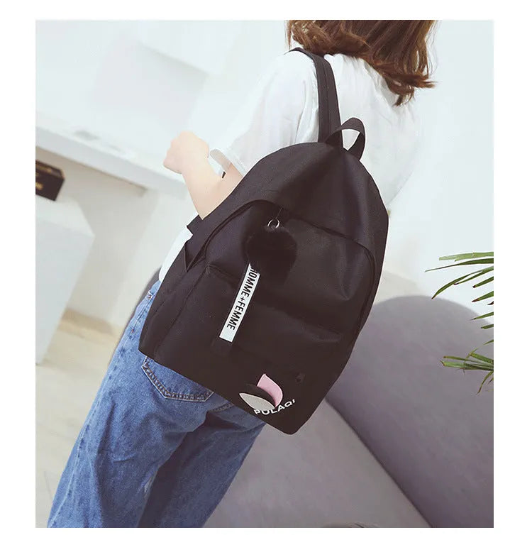 Green canvas college style schoolbag with structured design showing 40cm height and front compartment