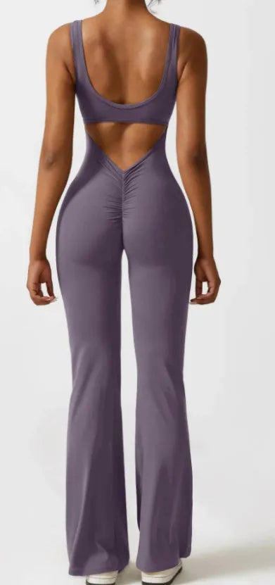 Close-up view of a black seamless women's yoga bodysuit with a mid-waist and trousers length.