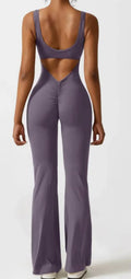 Close-up view of a black seamless women's yoga bodysuit with a mid-waist and trousers length.