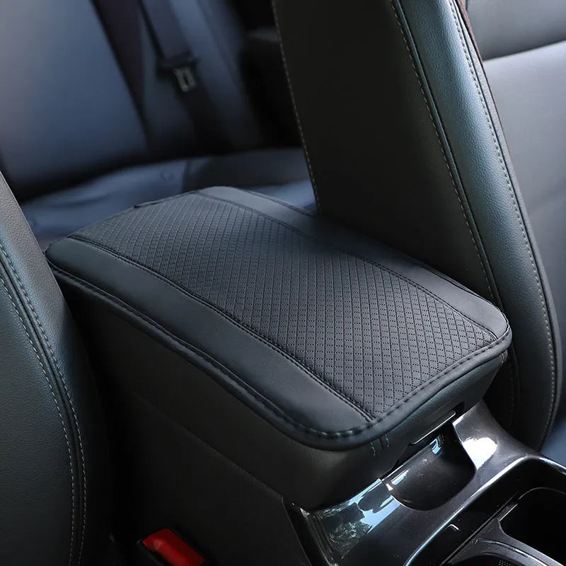Automotive fibre leather embossed armrest box mat measuring 32x19cm in black with red cord detailing