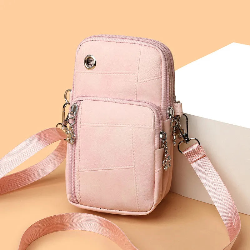 Vertical square mini mobile phone bag in PU leather with an exterior sandwich pocket.