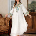 White long sleeve floor-length Arabic robe for women on a hanger