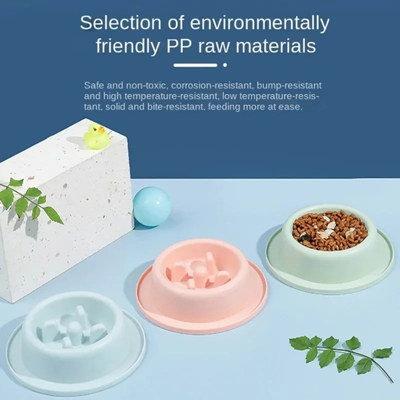 Pink pet slow feeder bowl with raised maze pattern and non-slip base on a floor