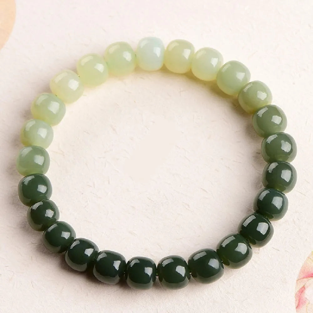 Polished Hetian jade bracelet with gradient clear water colour and round beads.