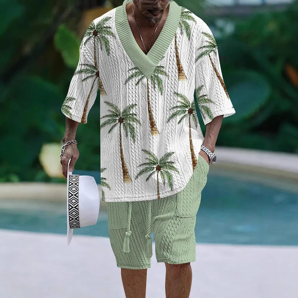 Man wearing a loose-fitting light blue short sleeve suit top and matching shorts, a casual two-piece set.