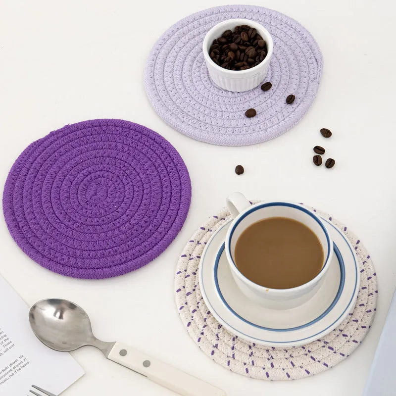 Three round cotton cord coasters in different colours showing 18cm diameter size