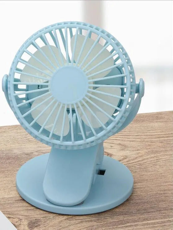White USB rechargeable clip fan with brushless motor attached to a desk edge.