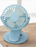 White USB rechargeable clip fan with brushless motor attached to a desk edge.