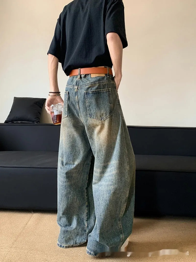 Men's retro blue distressed wide-leg jeans with micro-elastic cotton blend fabric showing distressed detailing
