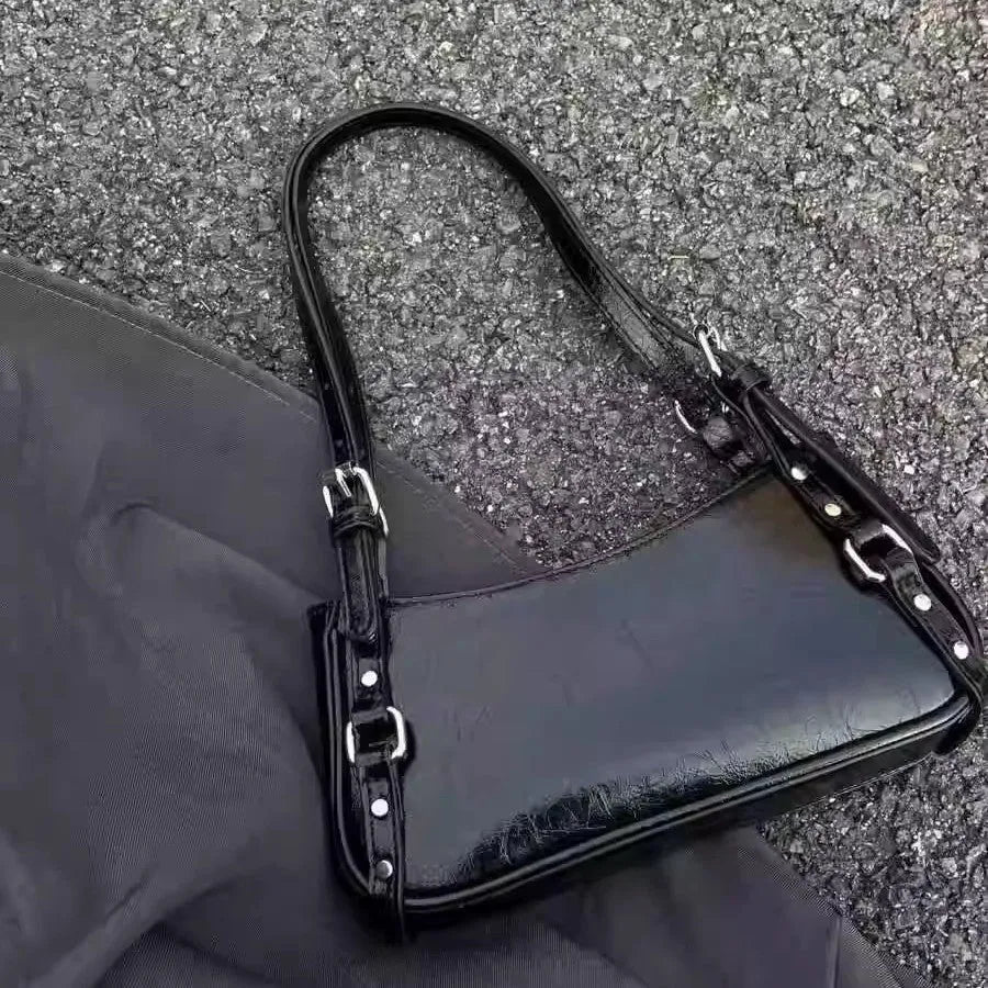 Black PU shoulder bag with horizontal square shape, outer three-dimensional pocket, and internal zipper change bag.