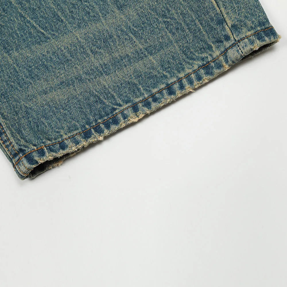 Retro distressed jeans for men in vintage blue cotton denim with worn-in finish, front view