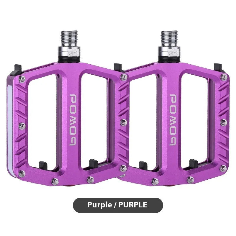 Aluminium alloy bicycle pedals with built-in 710LED lights in black, gold, purple, red, and titanium colour options.