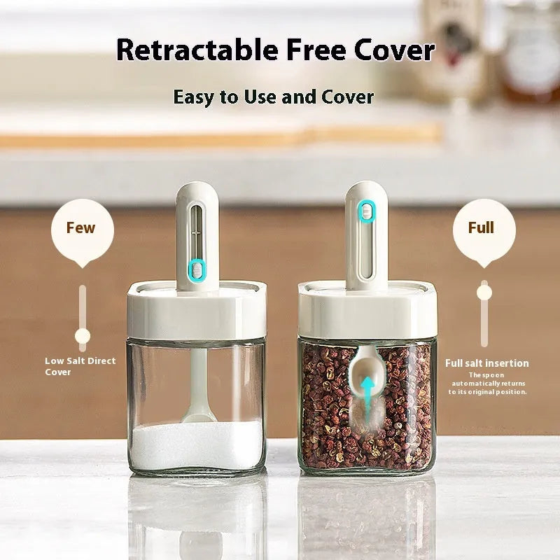 Retractable glass seasoning jar in Nordic style with green lid, showing clear glass body and dispensing mechanism