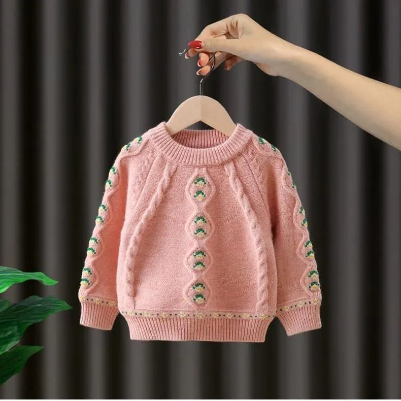 Girls pink knitted diamond flower pullover sweater with rabbit fur composition on white background