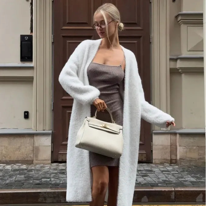 White knitted women's cardigan jacket with extended length and loose fit