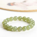 Polished Hetian jade ball bracelet showing ice-clear beads on a wrist, demonstrating deep clear water colour.