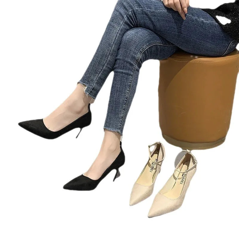 Women's black stiletto heel pumps with buckle detail and skull pattern lining
