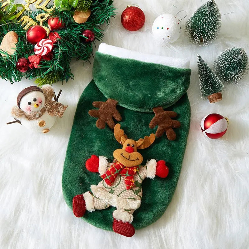 Small dog wearing a Christmas flannel hoodie in Red Santa Claus pattern standing on grass
