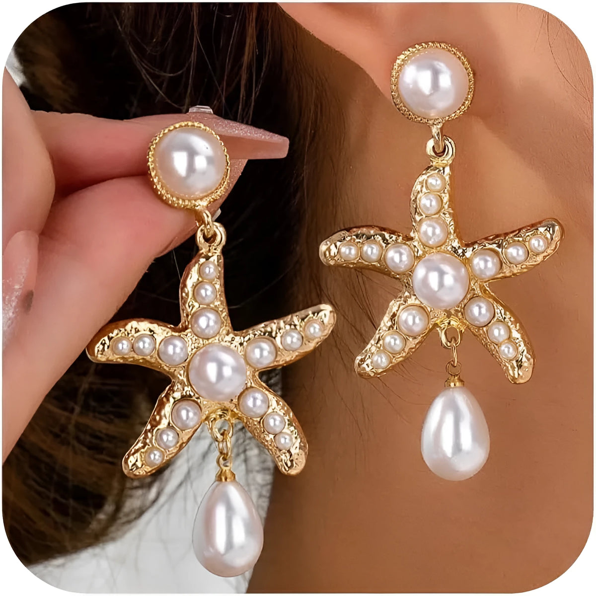 Women's gold-tone starfish drop earrings with a single off-white pearl centre on a light background