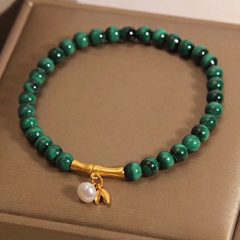 White crystal lucky bamboo bracelet with adjustable closure on a wrist.