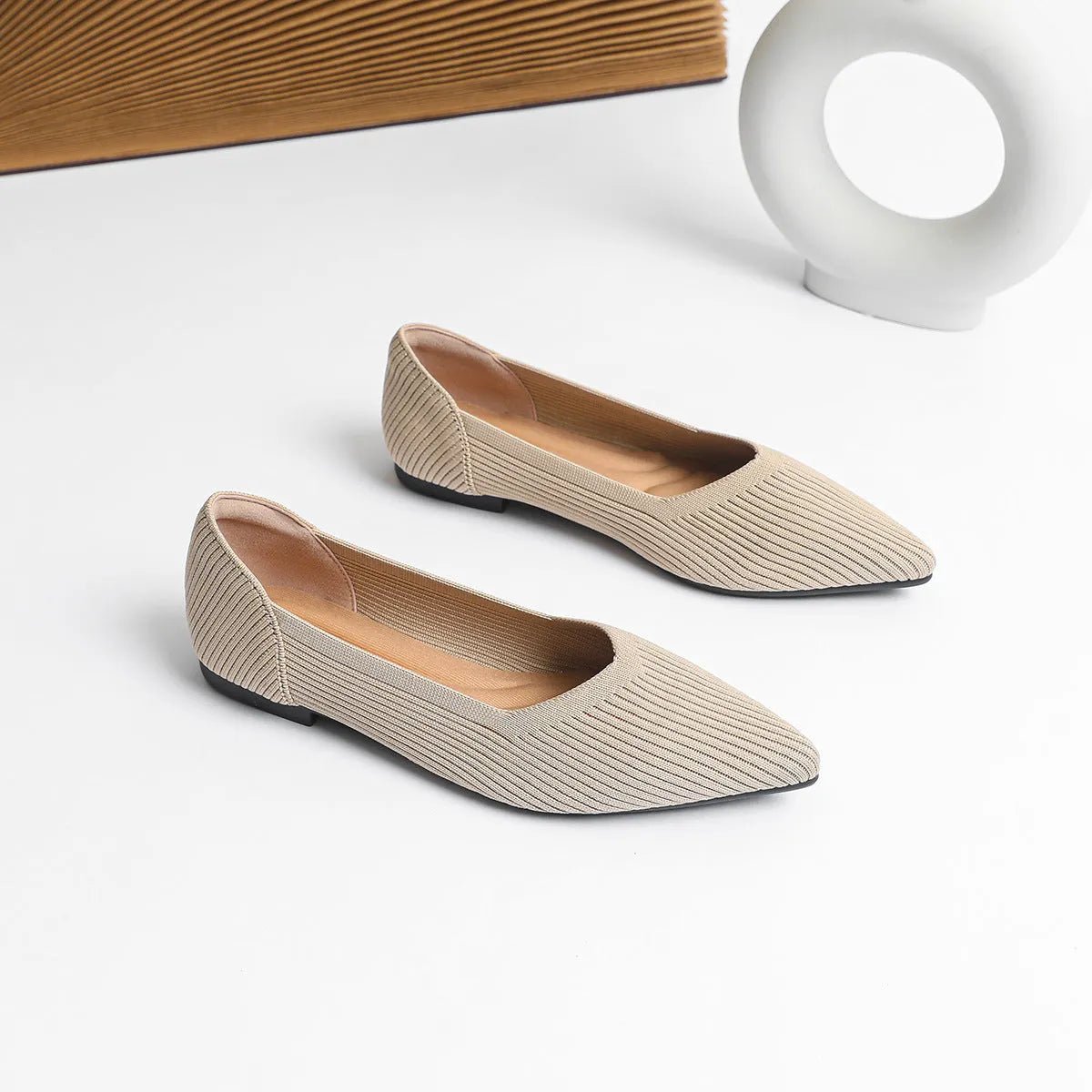 Women's apricot knit flat pump with pointed toe and rubber sole on a white background.