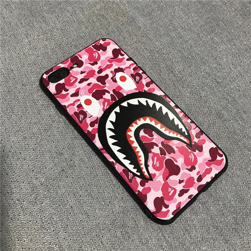 Frosted silicone phone case with shark mouth design in red, green, gray, and pink colours