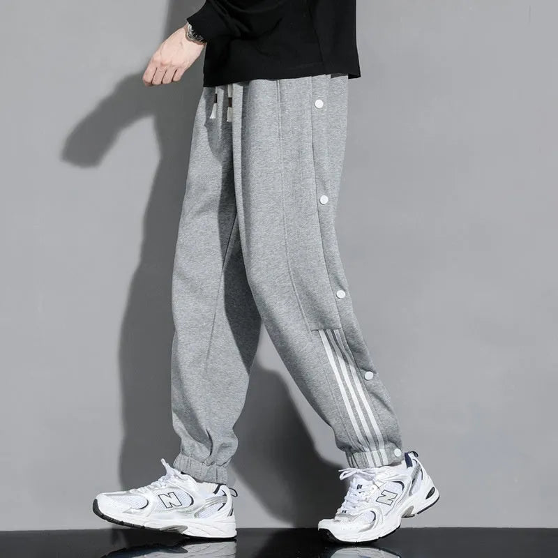 Men's black sports sweatpants with high waist, drawstring closure and ankle ties in cotton blend fabric