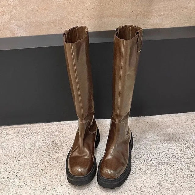 Black women's knee-high chunky heel boots with round toe and back zipper.