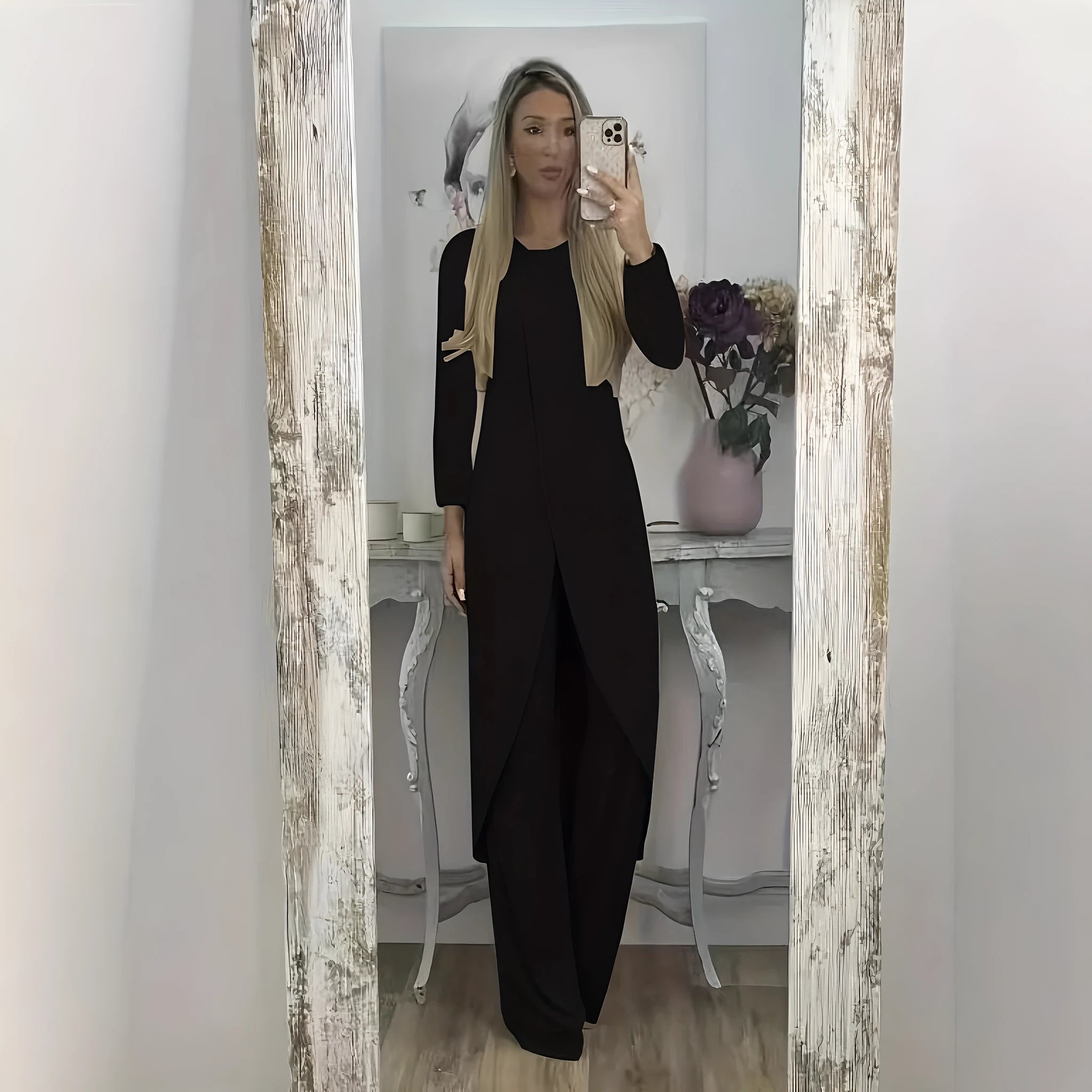 A loose-fitting black two-piece lounge set consisting of a long-sleeve round-neck top and matching trousers.