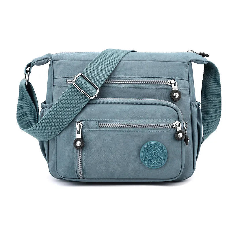 Soft nylon shoulder messenger bag in square vertical design, shown in grey colour.