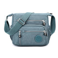 Soft nylon shoulder messenger bag in square vertical design, shown in grey colour.