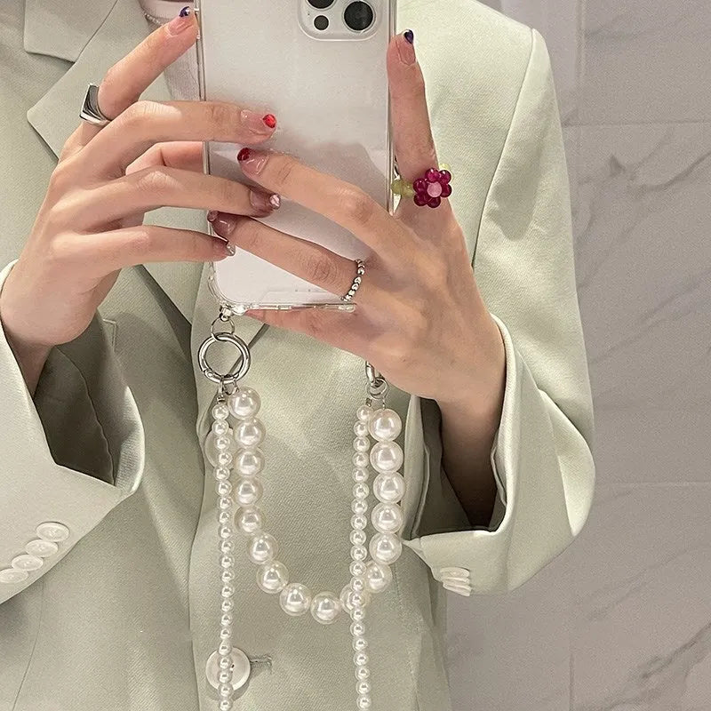 Soft mobile phone case with a white pearl charm chain attached, shown in a selected colour.