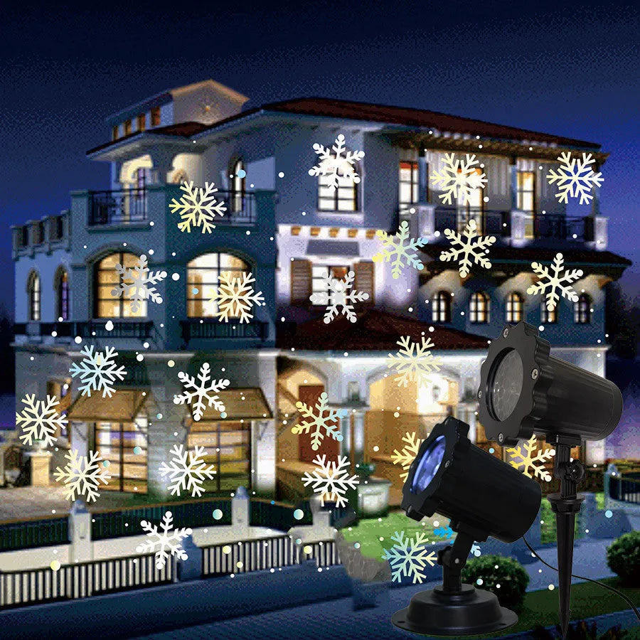 LED Christmas snowflake laser light projector IP65 waterproof with white snowflakes projecting onto a garden wall at night
