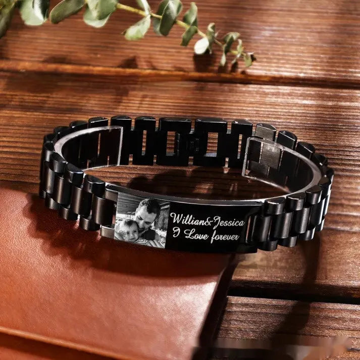 Titanium steel men's bracelet with curved heart shape design and black lettering on grey background