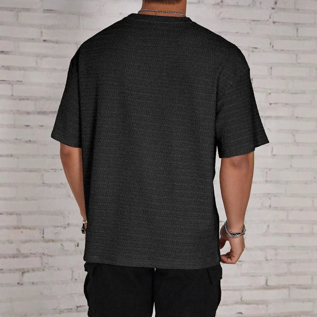 Men's slim fit solid colour round neck T-shirt on a hanger, shown in light blue.