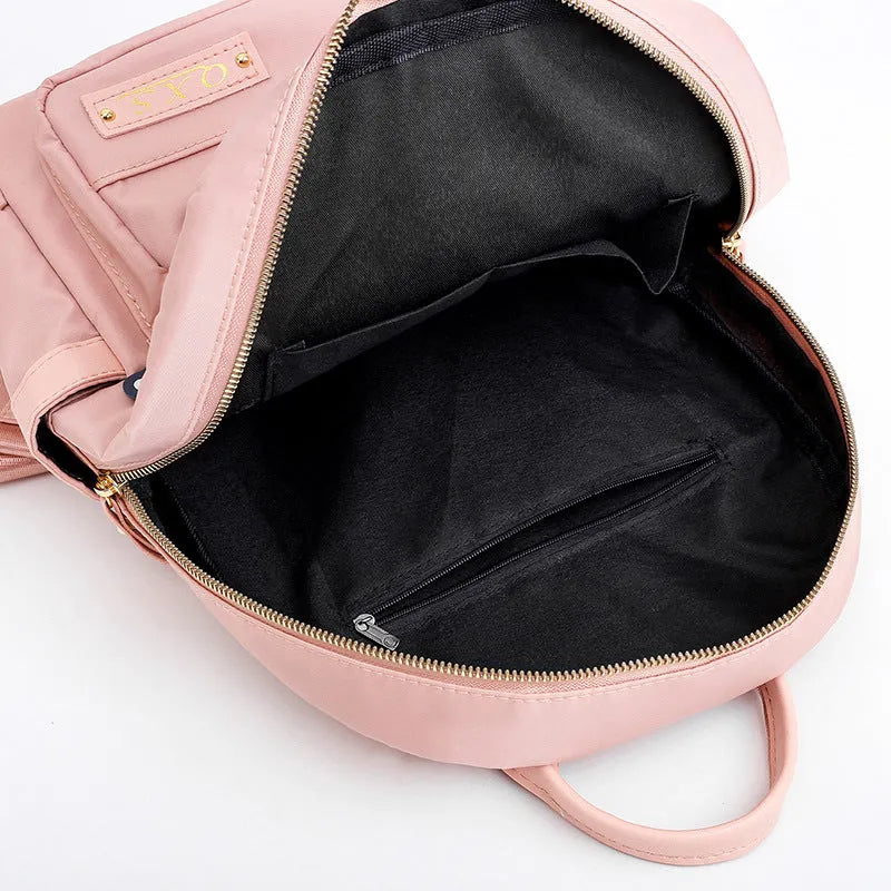 Women's black nylon casual backpack with double shoulder straps and front pocket