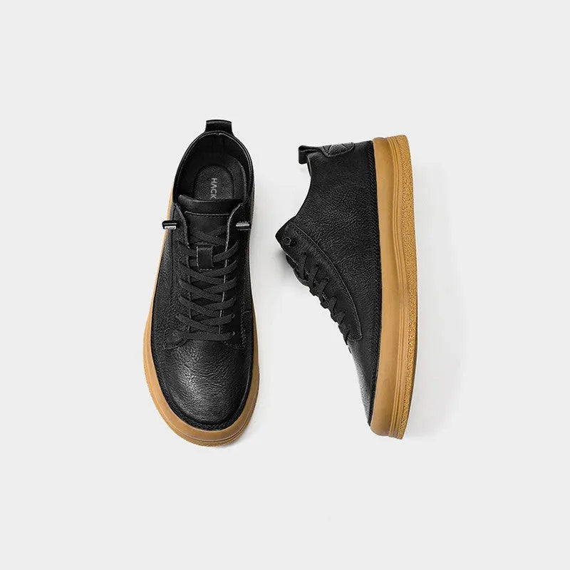 Men's black leather casual shoes with white soles and lace-up front.