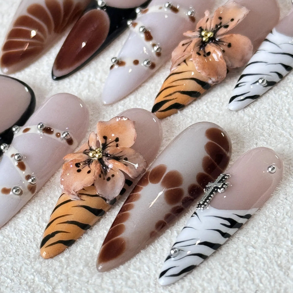 Handmade leopard print false eyelashes with cross and flower details on nail stickers.
