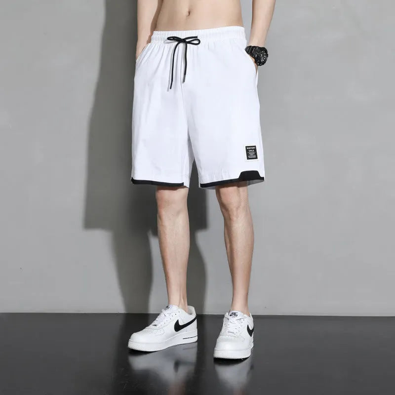 Boys' black cotton casual shorts with mid-waist, shown on a hanger.