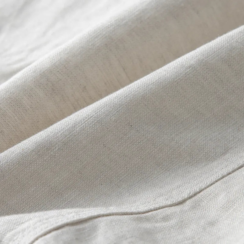 A man's casual linen suit jacket in a solid colour, shown with long sleeves and a loose fit.