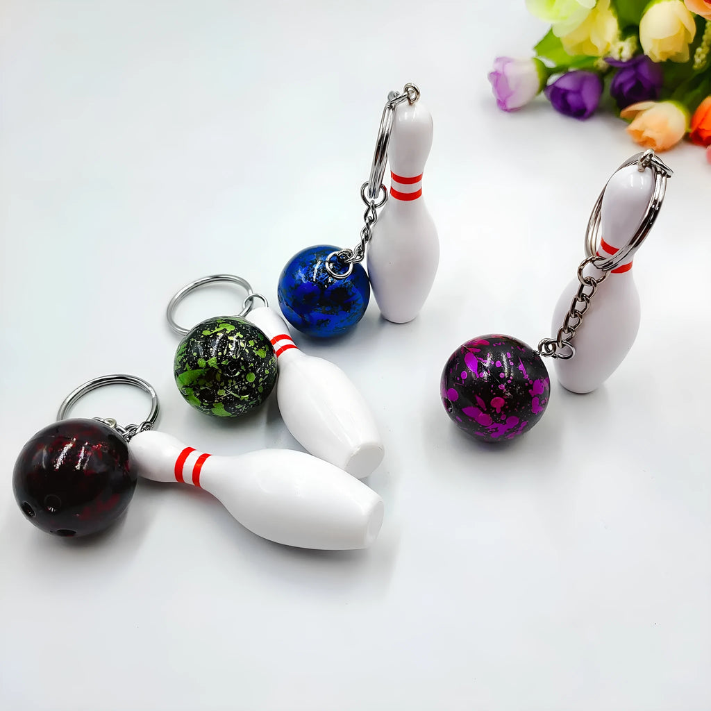 Mini bowling sports keychain pendant in four colour options: dark red, blue, purple, green