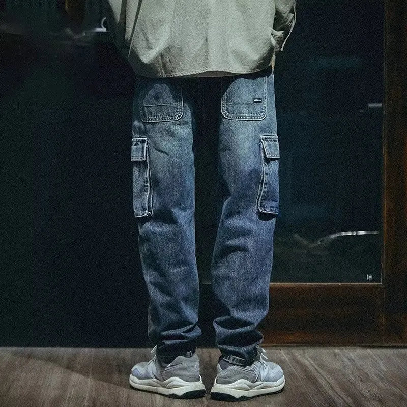 Men's blue loose straight-leg denim trousers with a zip fly placket laid flat.