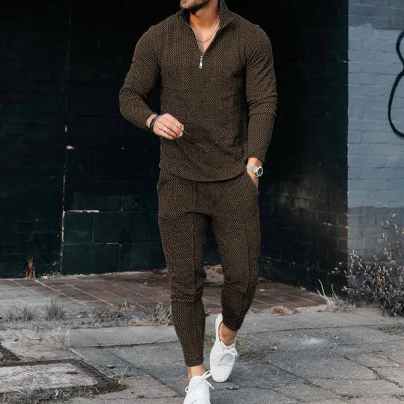 Men's grey sports and leisure loose suit set with polyester top and pants on a plain background