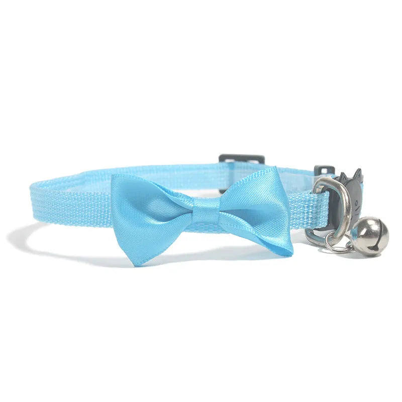 Adjustable nylon cat collar with decorative bow and bell in striped cartoon pattern, multiple colour options shown