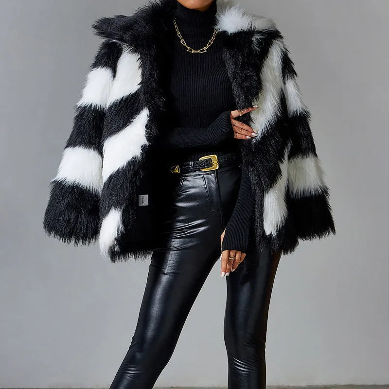 Women's grey faux fur coat with black contrast lapel and a large detachable faux fur collar.
