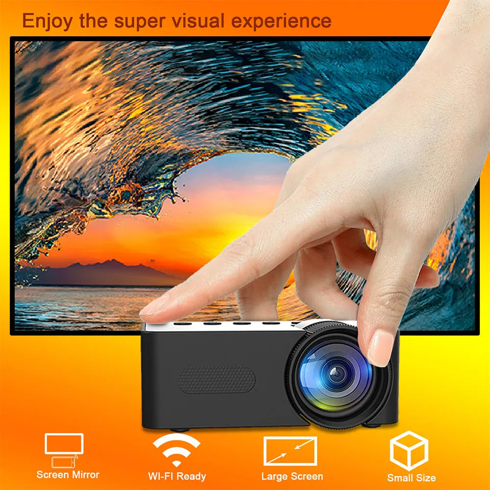 YT100 black mini portable projector on a desk with remote control and USB cable