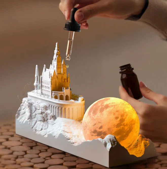Small mountain-shaped LED night light with touch control, shown as part of a gift box set with essential oil and card for bedroom or desktop decoration.